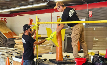 Korellis employees practicing setting up a safety guard rail system.